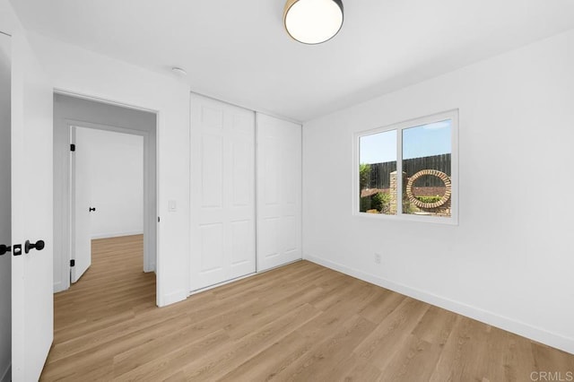 8184 Flanders Dr, San Diego, CA 92126 - unfurnished bedroom featuring light wood finished floors, baseboards, and a closet