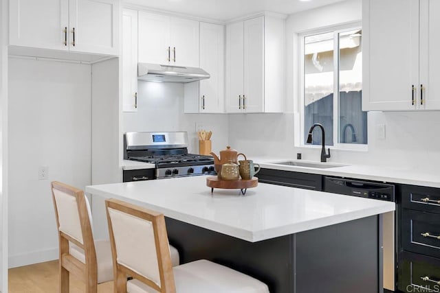 8184 Flanders Dr, San Diego, CA 92126 - kitchen featuring under cabinet range hood, a sink, gas range, light countertops, and a breakfast bar area