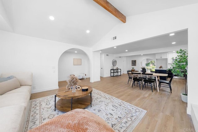 8184 Flanders Dr, San Diego, CA 92126 - living room featuring arched walkways, beamed ceiling, recessed lighting, light wood-style floors, and high vaulted ceiling