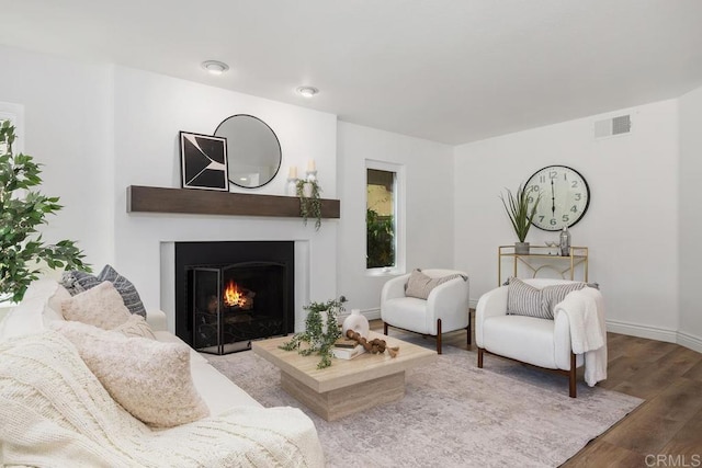 1707 Willowhaven Rd, Encinitas, CA 92024 - living room featuring wood finished floors, a warm lit fireplace, and baseboards