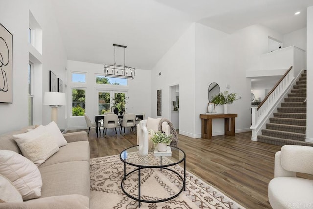 1707 Willowhaven Rd, Encinitas, CA 92024 - living room featuring high vaulted ceiling, a chandelier, wood finished floors, stairway, and baseboards