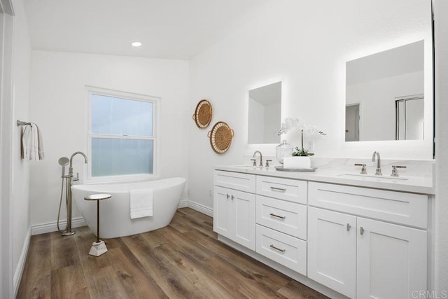 1707 Willowhaven Rd, Encinitas, CA 92024 - full bath with double vanity, a freestanding tub, baseboards, recessed lighting, and wood finished floors