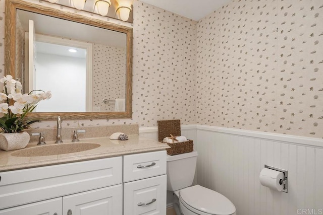 1707 Willowhaven Rd, Encinitas, CA 92024 - bathroom with wainscoting, toilet, wallpapered walls, and vanity