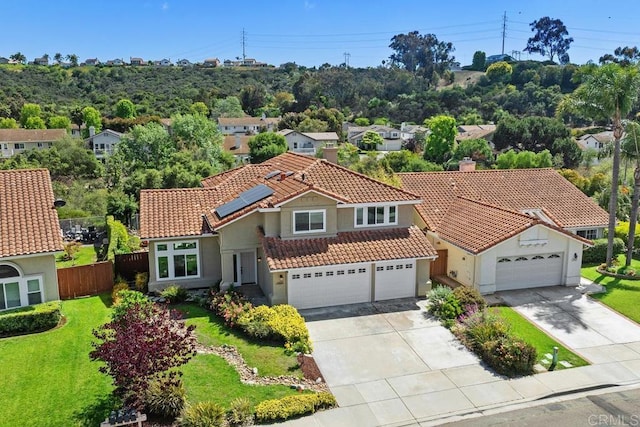 1707 Willowhaven Rd, Encinitas, CA 92024 - view of front of home with a tiled roof, concrete driveway, stucco siding, roof mounted solar panels, and a chimney