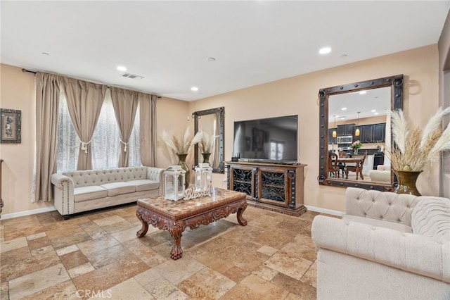 5801 S Moonstone Peak Dr, Bakersfield, CA 93313 - living room with stone tile flooring, baseboards, and recessed lighting