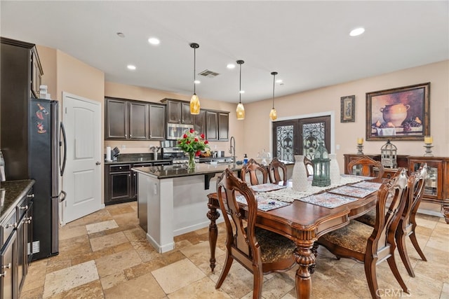 5801 S Moonstone Peak Dr, Bakersfield, CA 93313 - dining room with stone tile flooring, recessed lighting, and french doors