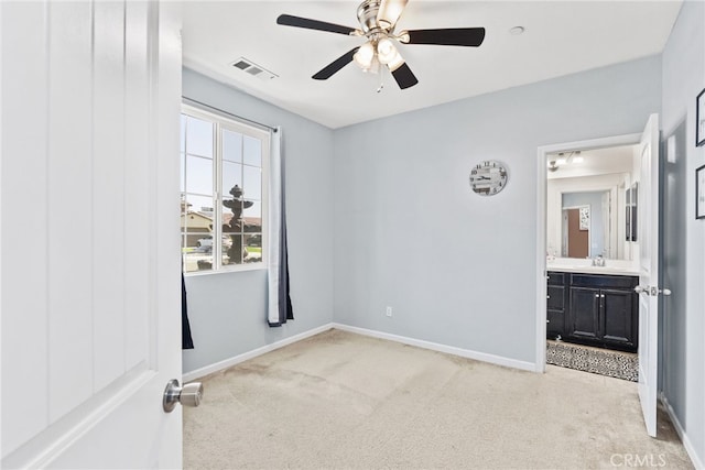 5801 S Moonstone Peak Dr, Bakersfield, CA 93313 - unfurnished bedroom featuring light colored carpet, a sink, baseboards, a ceiling fan, and connected bathroom