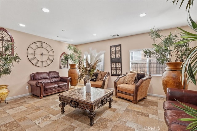 5801 S Moonstone Peak Dr, Bakersfield, CA 93313 - living room featuring stone tile flooring, baseboards, and recessed lighting