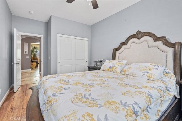 5801 S Moonstone Peak Dr, Bakersfield, CA 93313 - bedroom featuring a closet, wood finished floors, a ceiling fan, and arched walkways