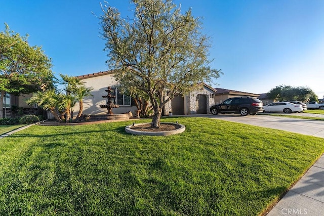 5801 S Moonstone Peak Dr, Bakersfield, CA 93313 - view of front of property featuring concrete driveway, a front yard, a garage, stucco siding, and a tiled roof