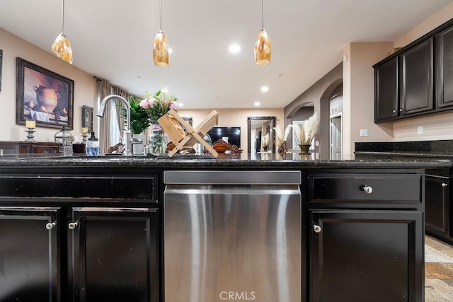 5801 S Moonstone Peak Dr, Bakersfield, CA 93313 - kitchen featuring dishwasher, a sink, hanging light fixtures, dark stone counters, and arched walkways