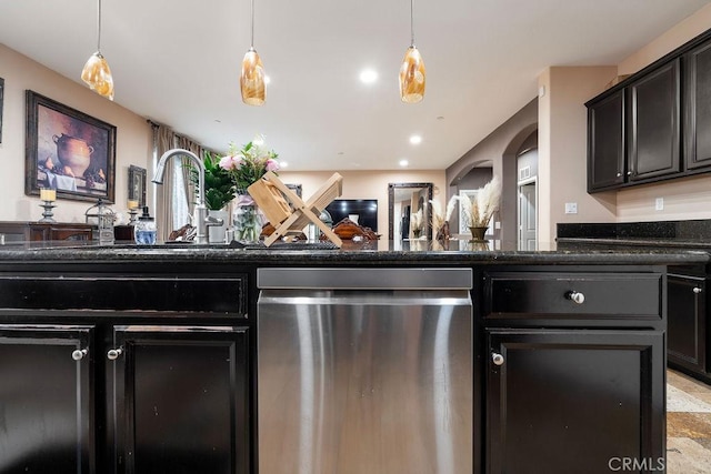 5801 S Moonstone Peak Dr, Bakersfield, CA 93313 - kitchen with dishwasher, hanging light fixtures, dark stone countertops, and arched walkways