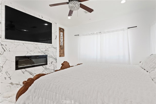 5801 S Moonstone Peak Dr, Bakersfield, CA 93313 - bedroom with recessed lighting, a premium fireplace, and a ceiling fan