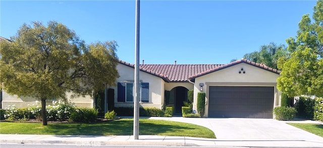 28465 Port Cv, Menifee, CA 92585 - mediterranean / spanish house featuring a tiled roof, stucco siding, a garage, concrete driveway, and a front yard