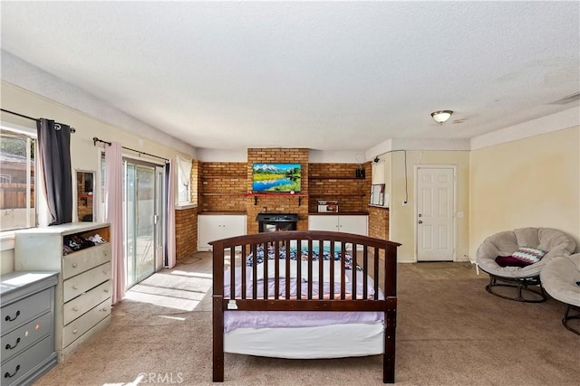 16193 Colina St, Victorville, CA 92395 - carpeted bedroom with a brick fireplace, access to outside, and a textured ceiling
