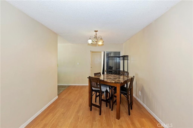 16193 Colina St, Victorville, CA 92395 - dining room with a chandelier, light wood-style flooring, baseboards, and a textured ceiling