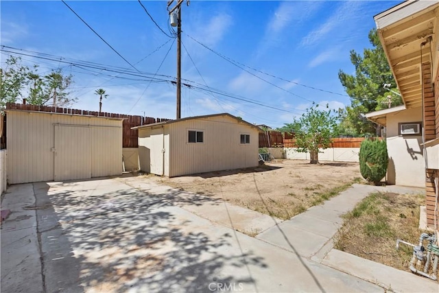 16193 Colina St, Victorville, CA 92395 - view of yard featuring a shed, fence, an outdoor structure, and a patio area