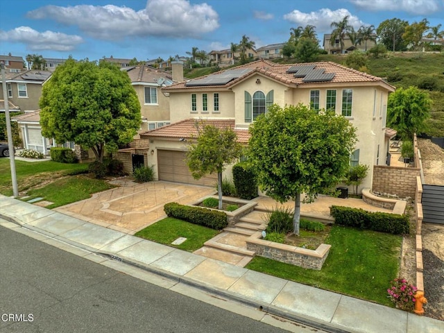 23839 Rio Ranch Way, Valencia, CA 91354 - mediterranean / spanish house featuring stucco siding, a garage, driveway, and a front lawn