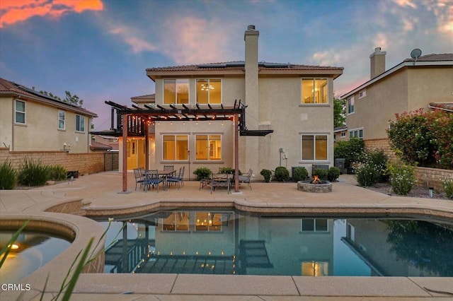 23839 Rio Ranch Way, Valencia, CA 91354 - rear view of property with solar panels, a pergola, an outdoor fire pit, a patio, and stucco siding