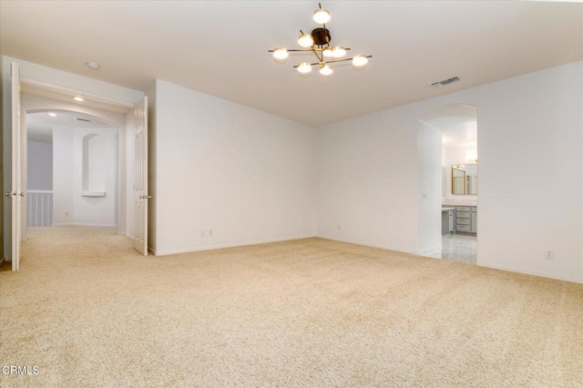 23839 Rio Ranch Way, Valencia, CA 91354 - spare room featuring arched walkways, light colored carpet, baseboards, and a chandelier
