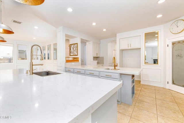23839 Rio Ranch Way, Valencia, CA 91354 - kitchen with a sink, recessed lighting, a kitchen island with sink, white cabinets, and light tile patterned floors