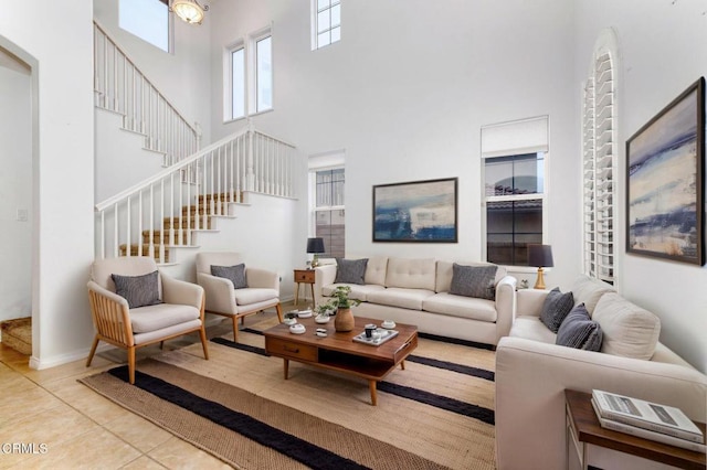 23839 Rio Ranch Way, Valencia, CA 91354 - living area with a towering ceiling, stairway, tile patterned floors, and baseboards