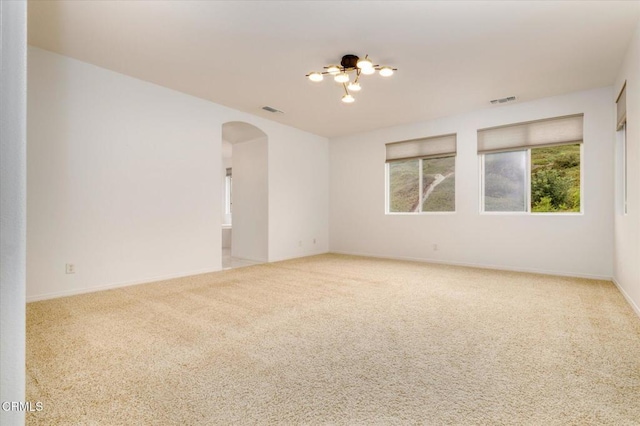 23839 Rio Ranch Way, Valencia, CA 91354 - carpeted spare room with arched walkways, healthy amount of natural light, baseboards, and a chandelier