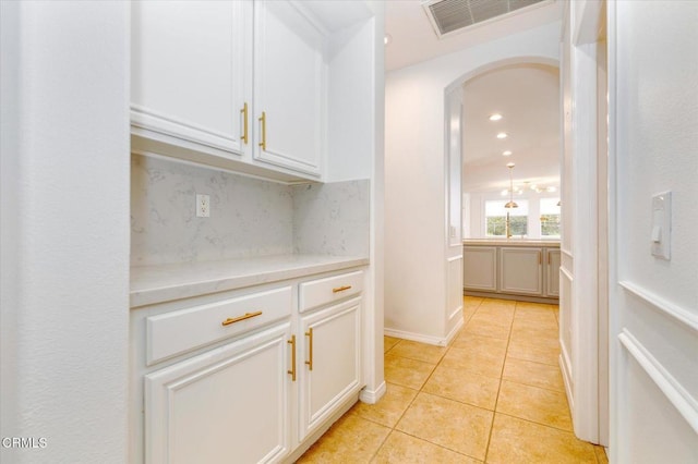 23839 Rio Ranch Way, Valencia, CA 91354 - corridor with arched walkways, light tile patterned flooring, and recessed lighting