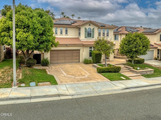 23839 Rio Ranch Way, Valencia, CA 91354 - mediterranean / spanish-style home with stucco siding, concrete driveway, a tile roof, roof mounted solar panels, and an attached garage