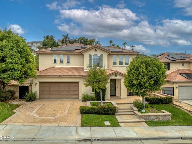23839 Rio Ranch Way, Valencia, CA 91354 - mediterranean / spanish home with stucco siding, a tile roof, a garage, driveway, and roof mounted solar panels