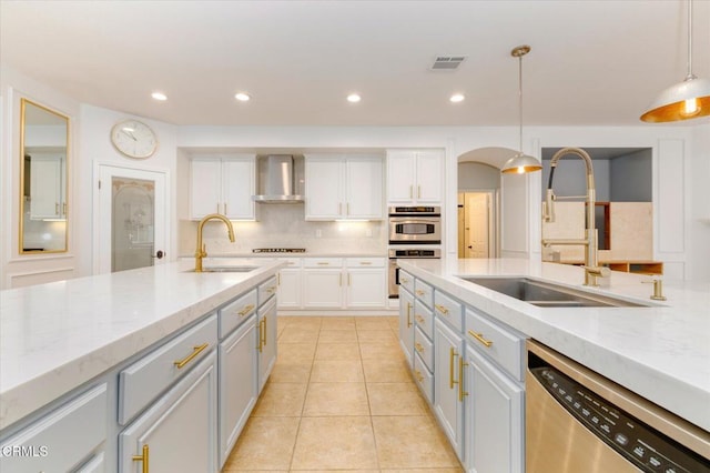23839 Rio Ranch Way, Valencia, CA 91354 - kitchen with stainless steel appliances, a sink, wall chimney exhaust hood, white cabinetry, and recessed lighting