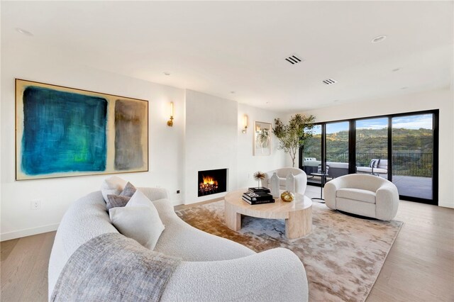 4335 Chaumont Rd, Woodland Hills, CA 91364 - living room with a warm lit fireplace, wood finished floors, baseboards, and recessed lighting
