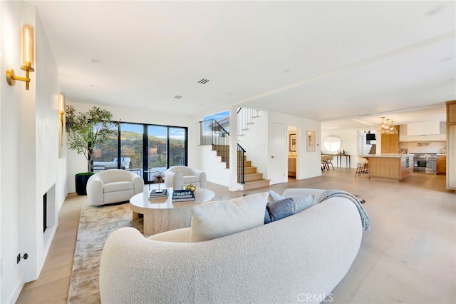 4335 Chaumont Rd, Woodland Hills, CA 91364 - living area featuring stairway, a chandelier, a fireplace, and baseboards