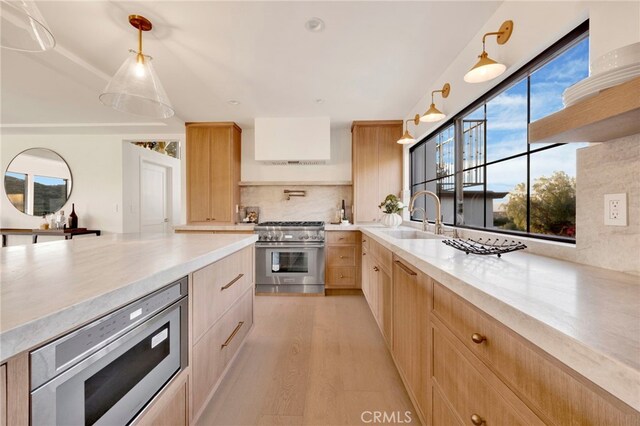 4335 Chaumont Rd, Woodland Hills, CA 91364 - kitchen featuring appliances with stainless steel finishes, light brown cabinetry, a sink, light countertops, and tasteful backsplash