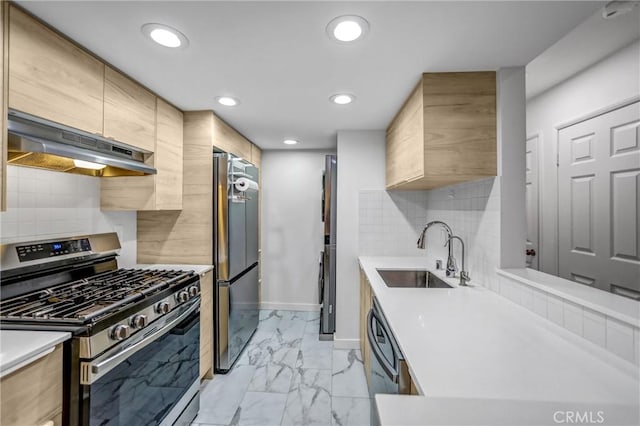 460 Oak St Unit 316, Glendale, CA 91204 - kitchen featuring stainless steel range with gas cooktop, under cabinet range hood, a sink, freestanding refrigerator, and light marble finish floors