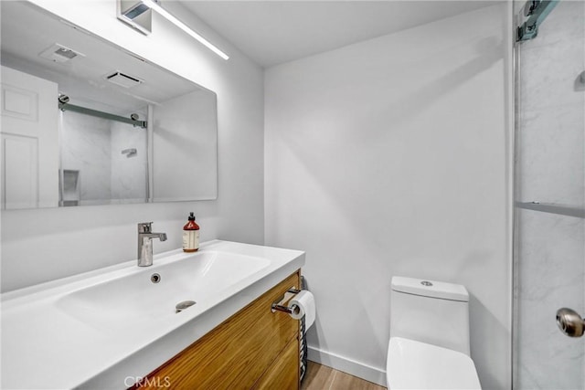 460 Oak St Unit 316, Glendale, CA 91204 - bathroom featuring a shower with shower door, toilet, wood finished floors, vanity, and baseboards