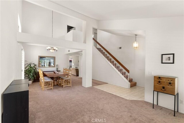 21242 Bristlecone, Mission Viejo, CA 92692 - living area featuring a chandelier, stairs, carpet flooring, and a towering ceiling