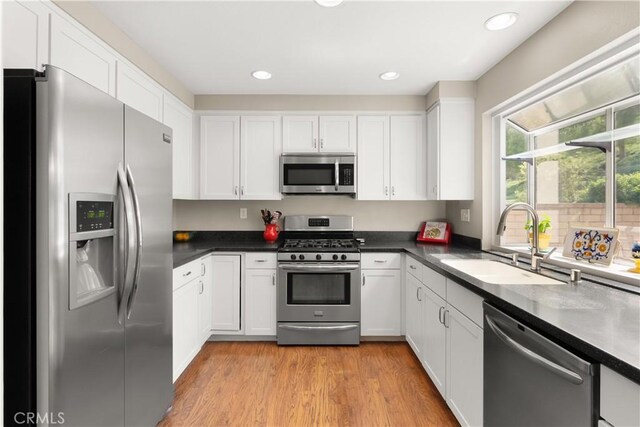 21242 Bristlecone, Mission Viejo, CA 92692 - kitchen with appliances with stainless steel finishes, a sink, white cabinetry, dark countertops, and recessed lighting