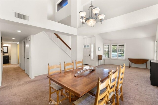21242 Bristlecone, Mission Viejo, CA 92692 - dining area with light colored carpet, a chandelier, stairway, and a high ceiling