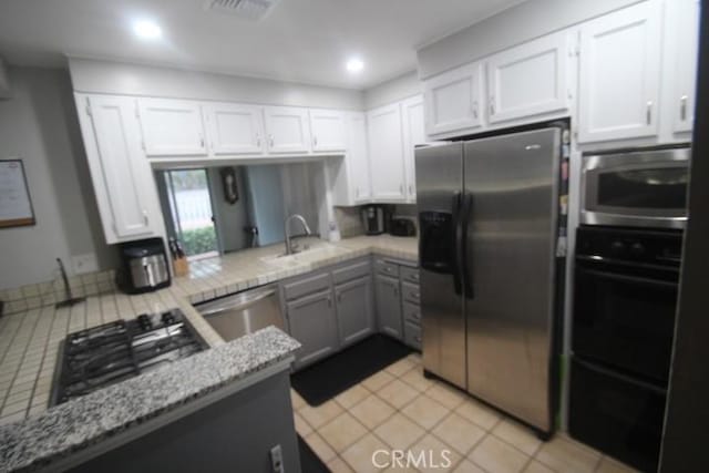 19555 Chadway St, Canyon Country, CA 91351 - kitchen featuring stainless steel appliances, a sink, white cabinetry, light stone countertops, and recessed lighting