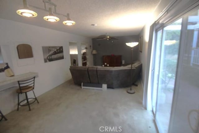 19555 Chadway St, Canyon Country, CA 91351 - living area with a ceiling fan, vaulted ceiling, carpet flooring, and a textured ceiling
