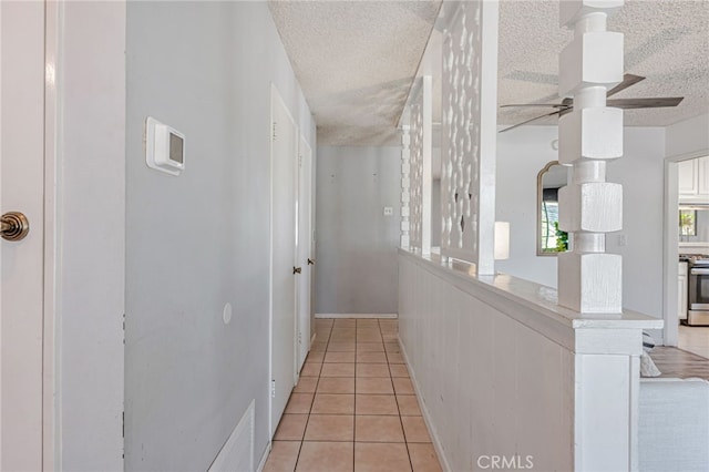 27049 Langside Ave, Canyon Country, CA 91351 - hall with light tile patterned floors, a textured ceiling, and baseboards