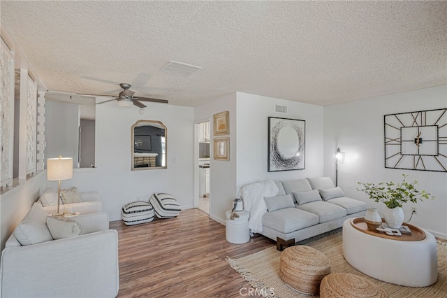 27049 Langside Ave, Canyon Country, CA 91351 - living area with wood finished floors, a ceiling fan, a textured ceiling, and baseboards