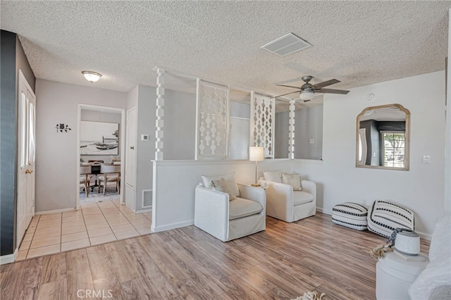 27049 Langside Ave, Canyon Country, CA 91351 - living area with wood finished floors, a ceiling fan, a textured ceiling, and baseboards