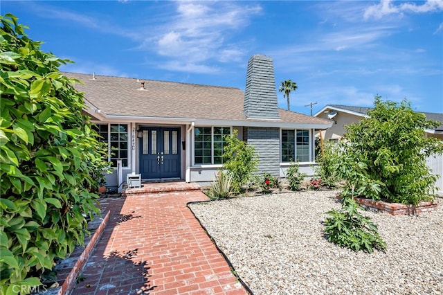 27049 Langside Ave, Canyon Country, CA 91351 - doorway to property with roof with shingles and a chimney