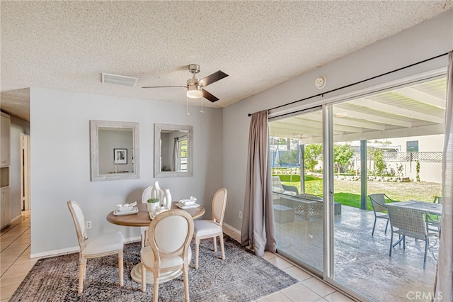 27049 Langside Ave, Canyon Country, CA 91351 - dining room featuring light tile patterned flooring, a ceiling fan, a textured ceiling, and baseboards