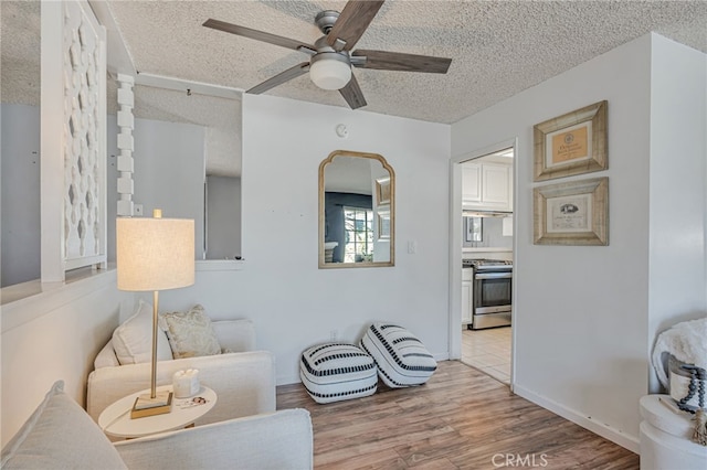 27049 Langside Ave, Canyon Country, CA 91351 - living area with a textured ceiling, a ceiling fan, and wood finished floors