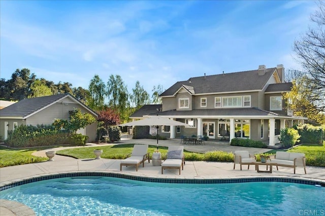 38161 Butterfly Ct, Yucaipa, CA 92399 - back of property with a patio, an outdoor pool, and a chimney