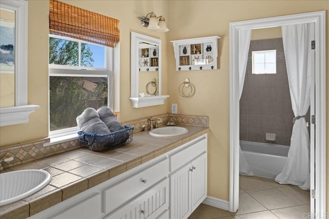 38161 Butterfly Ct, Yucaipa, CA 92399 - bathroom with healthy amount of natural light, double vanity, tile patterned flooring, and shower / tub combo