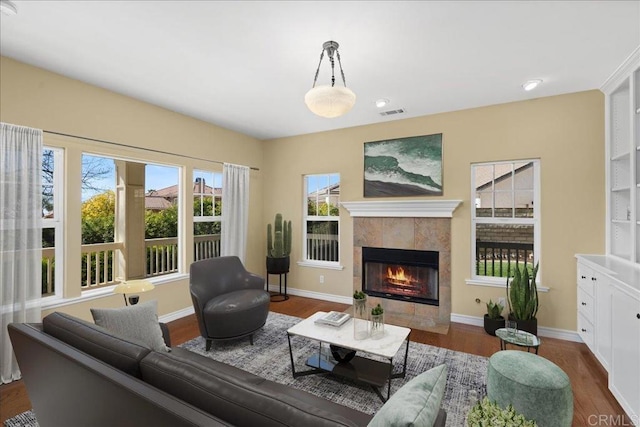 38161 Butterfly Ct, Yucaipa, CA 92399 - living area featuring dark wood-style floors, healthy amount of natural light, a fireplace, baseboards, and recessed lighting